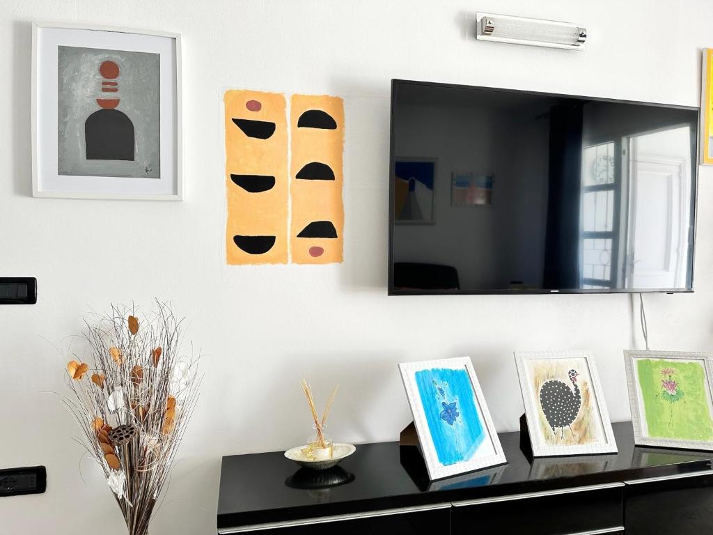 a black table with pictures on a wall with a mirror at Relaxing Ocean View, Spacious Art Apartment With Large Terrace, Near Best Costa Adeje Beaches in Adeje