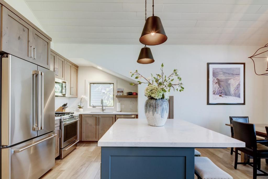 a kitchen with a vase of flowers on a counter at Luxury Condo & Professional Design, Free Shuttle & Hot Tub! Deer Valley Comstock Lodge 307 in Park City