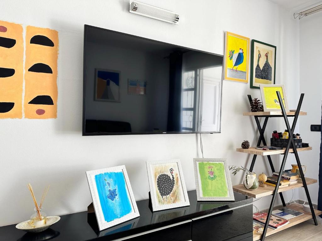 a room with a table with paintings on the wall at Relaxing Ocean View, Spacious Art Apartment With Large Terrace, Near Best Costa Adeje Beaches in Adeje