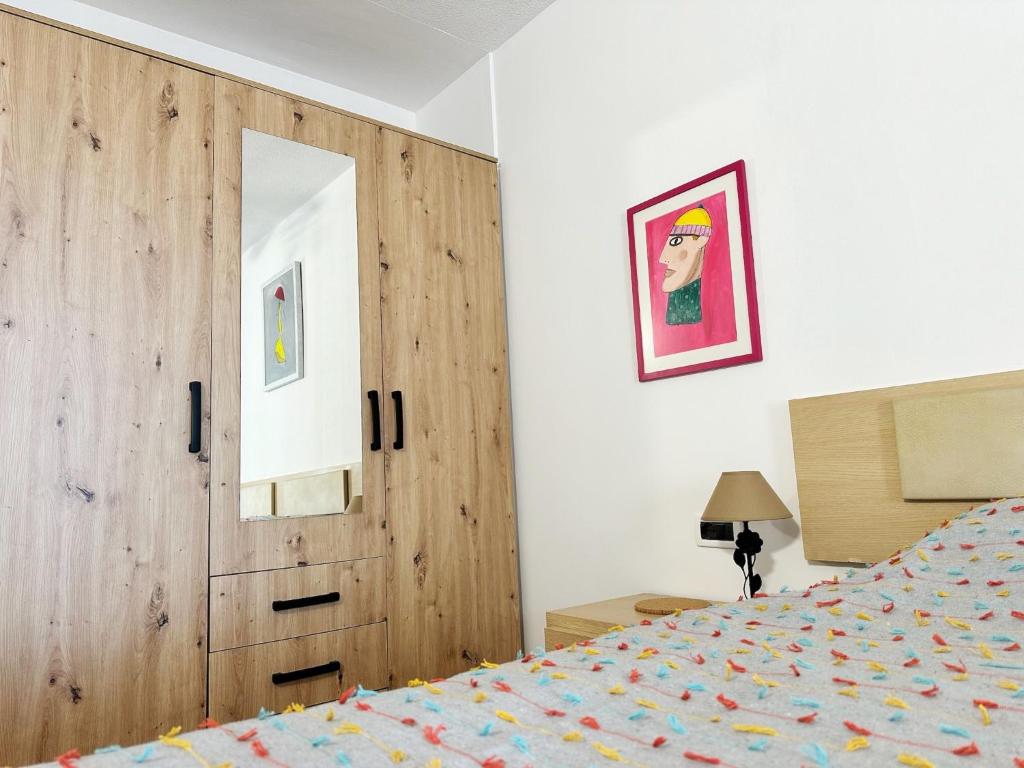 a bedroom with a wooden door and a bed at Relaxing Ocean View, Spacious Art Apartment With Large Terrace, Near Best Costa Adeje Beaches in Adeje