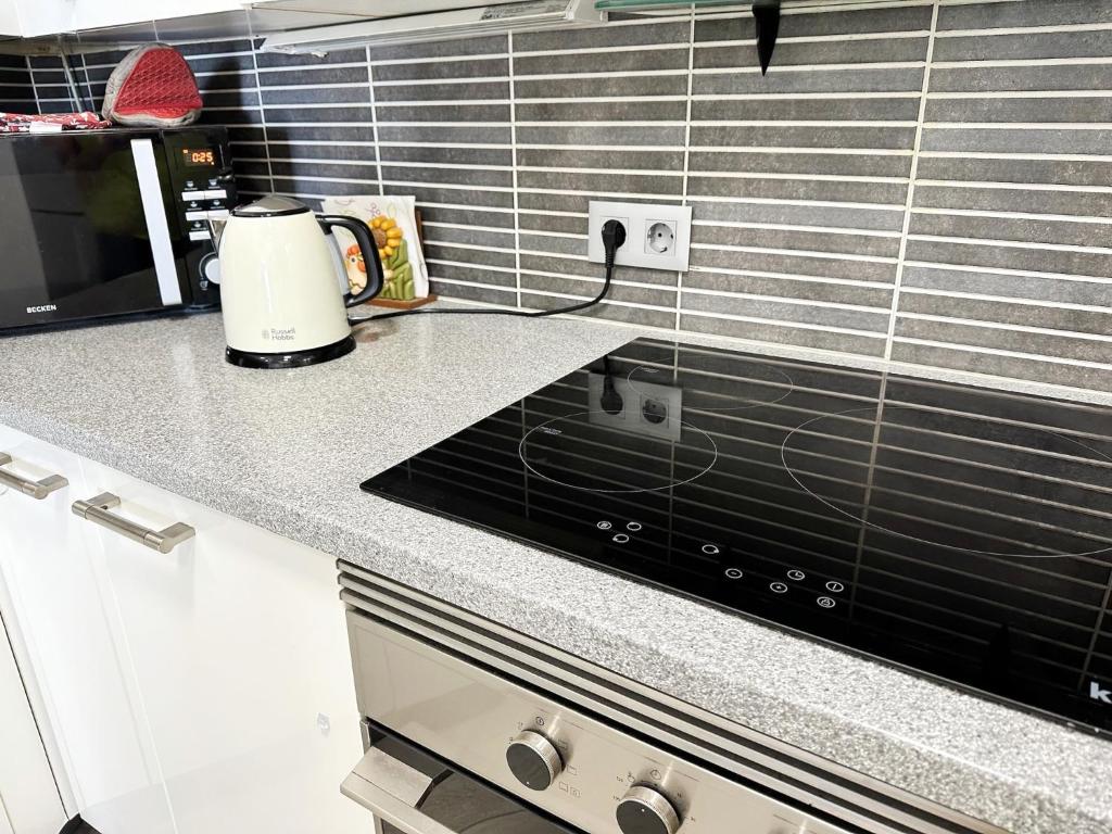 a kitchen counter with a toaster and a stove at Relaxing Ocean View, Spacious Art Apartment With Large Terrace, Near Best Costa Adeje Beaches in Adeje