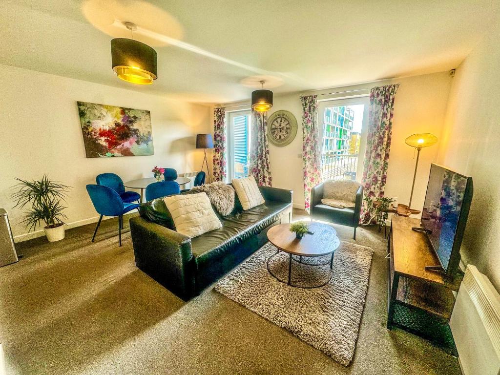 a living room with a couch and a table at Blueberry Tree Apartment in Cambridge