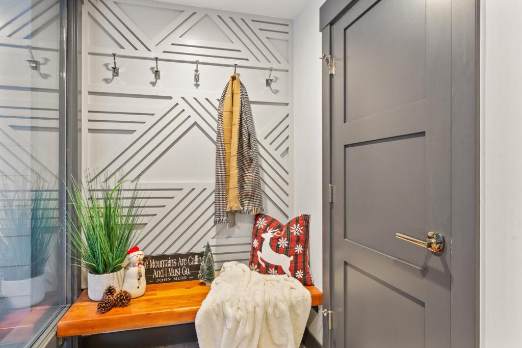 a hallway with a wooden bench next to a door at Enjoy a Modern Luxury Design, Central Location, Hot Tub & Recreation! Deer Valley Fawngrove 1674 in Park City