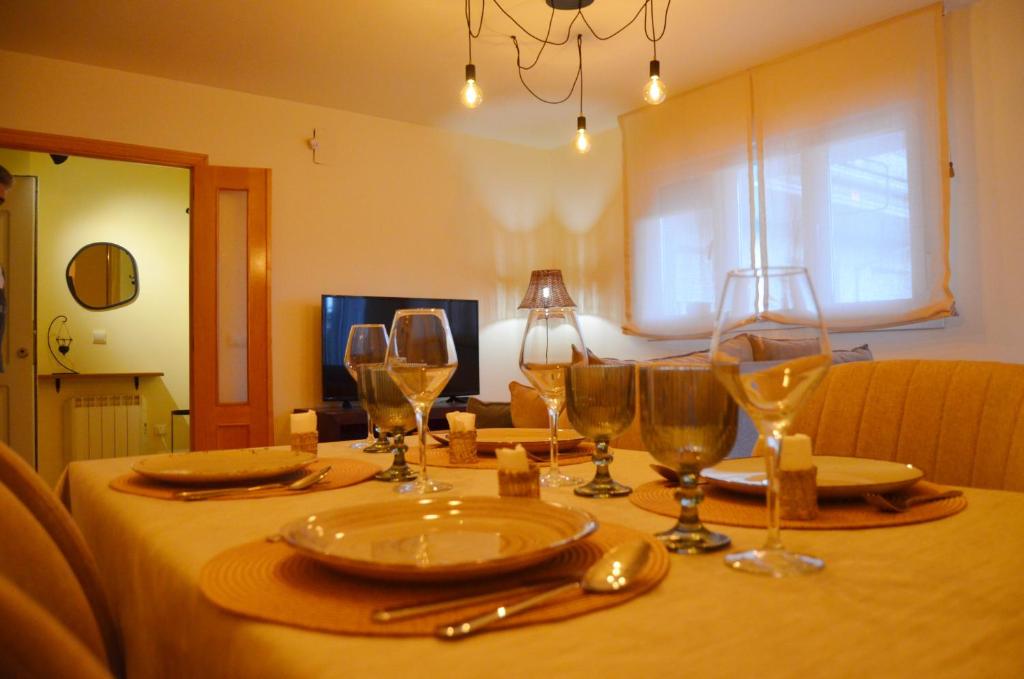 a table with wine glasses on top of it at Ojaranzo in Candeleda