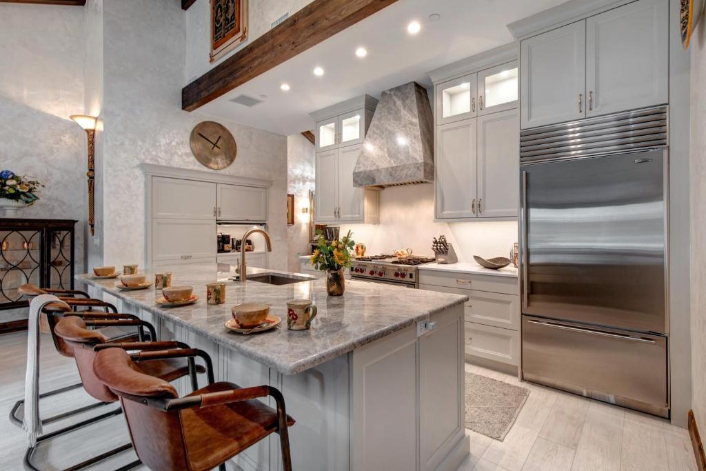 a kitchen with white cabinets and a large kitchen island at Enjoy a Modern Luxury Design, Central Location, Hot Tub & Recreation! Deer Valley Fawngrove Estate in Park City
