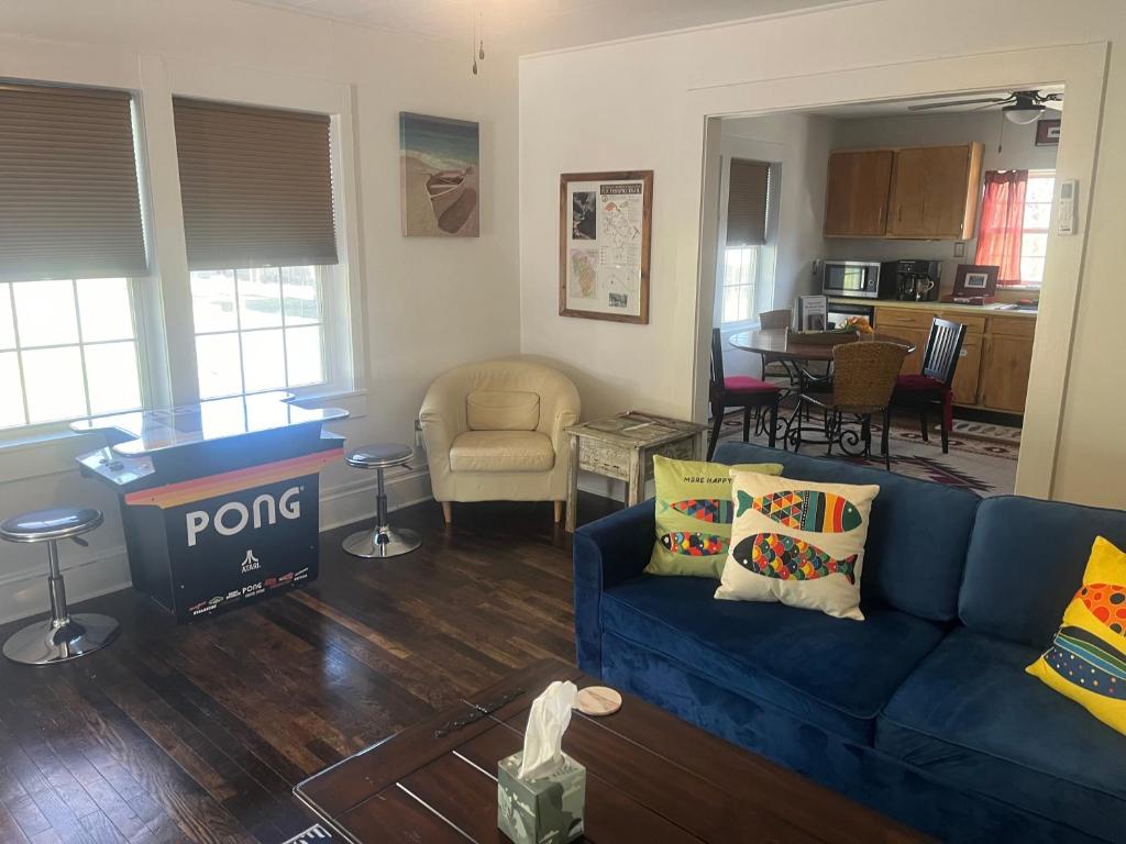 a living room with a blue couch and a kitchen at The Bait & Tackle - Newly renovated suite apt 2 in Bryson City