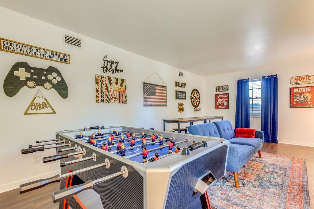 a living room with a large foosball table at Family-Friendly Home 6 Mi to Downtown Mobile! in Mobile