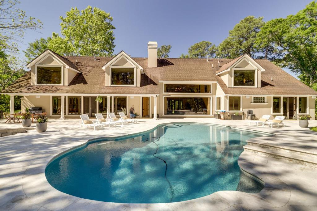 a house with a swimming pool in front of a house at Private Estate on 25 Acres Fishing and Canoeing! in Houston