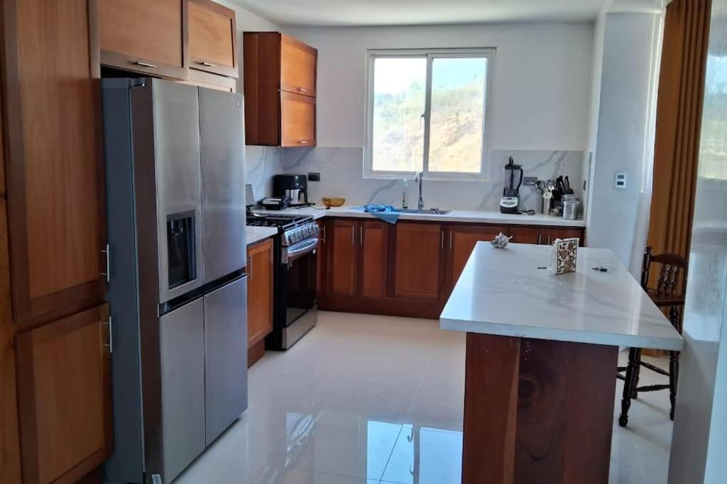 a kitchen with a refrigerator and a table in it at Appartamento Sidney in San Fernando de Monte Cristi