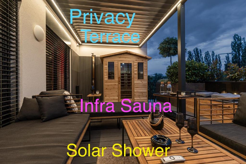 a patio with a sofa and a sign on it at DH Private Flowers Terrace and Sauna Luxury Apartment 2kk, 2x SmartTV-NETFLIX, Free Parking, Gym in Brno
