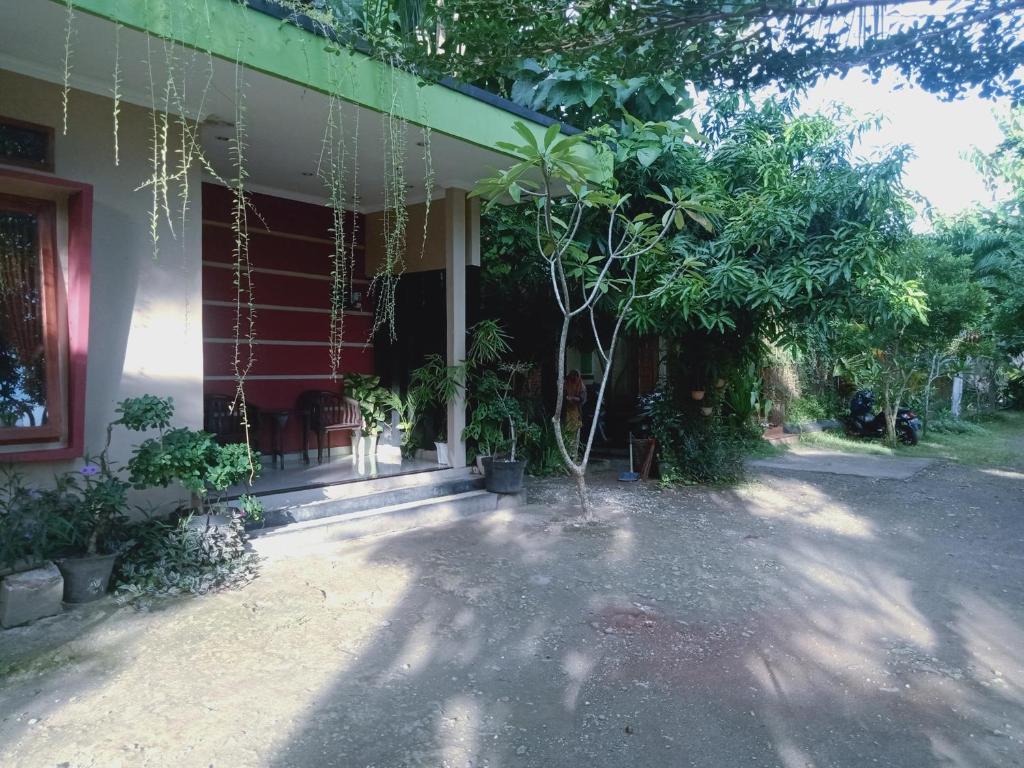 a house with a porch with plants on it at Griya PAS Pangandaran in Pangandaran