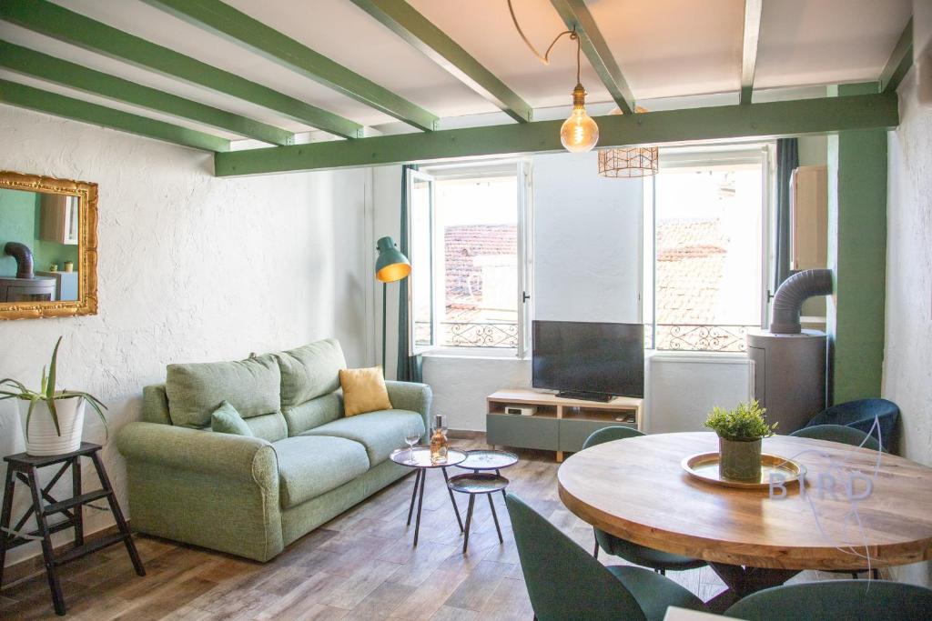 a living room with a couch and a table at Charming town house in the heart of Suquet in Cannes