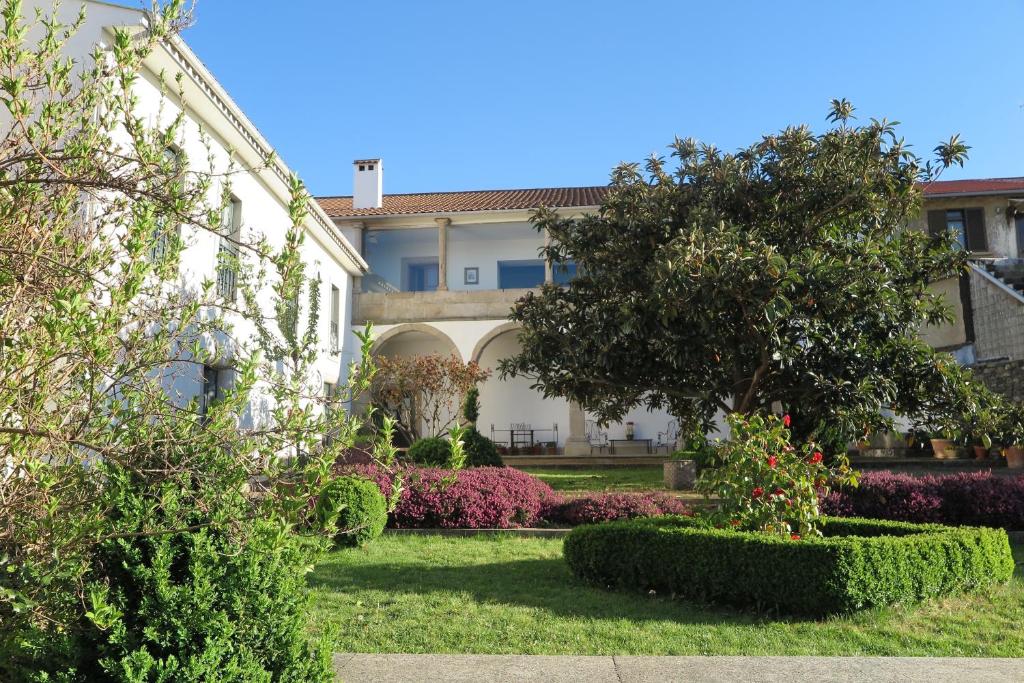a garden in front of a building with trees and bushes at Solar de Santa Maria in Bragança