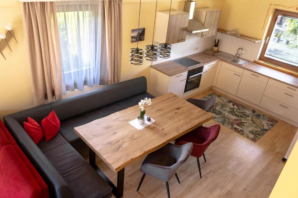 - un salon avec un canapé et une table en bois dans l'établissement Haus Morgenrot, à Weissensee