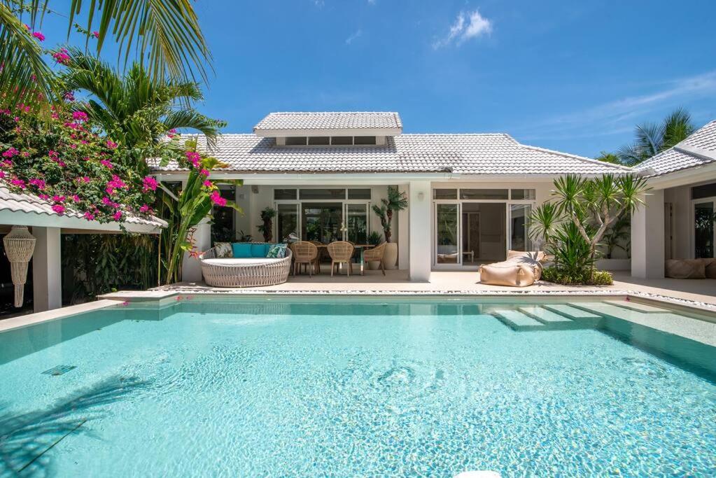 a swimming pool in front of a house at Luxury Villa MISS KOH Bophut in Koh Samui 