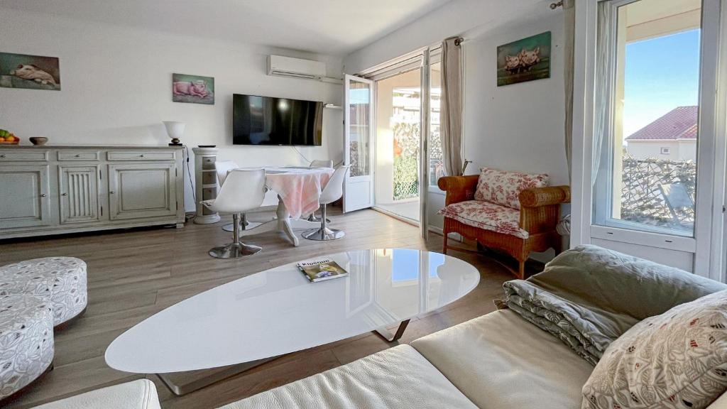 ein Wohnzimmer mit einem Sofa und einem Tisch in der Unterkunft 3 Pieces Agreable, Confortable in Cannes