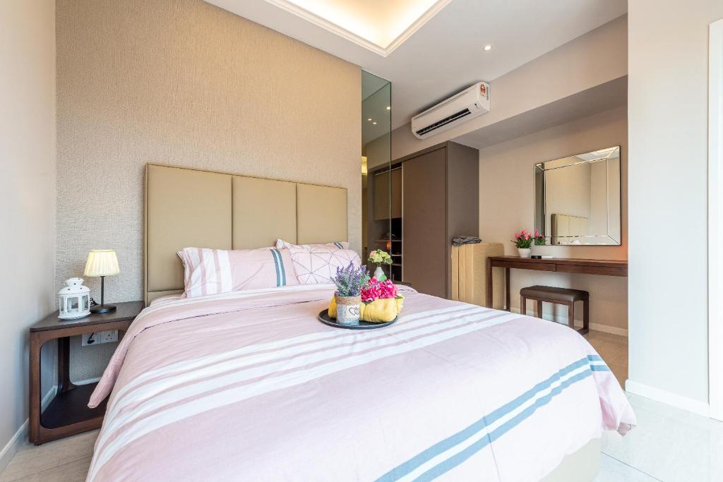 a bedroom with a large white bed with flowers on it at Dorsett Residences Sri Hartamas (Kuala Lumpur) in Kuala Lumpur