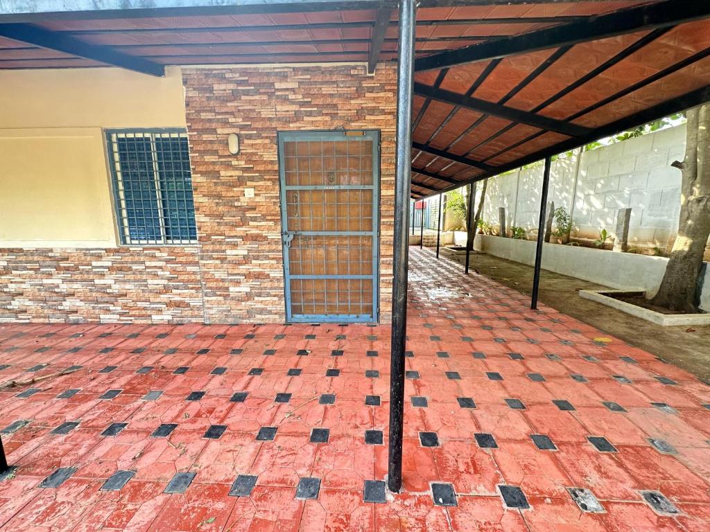 un edificio in mattoni con una porta su un pavimento di mattoni di Parvati Home Stay a Mysore