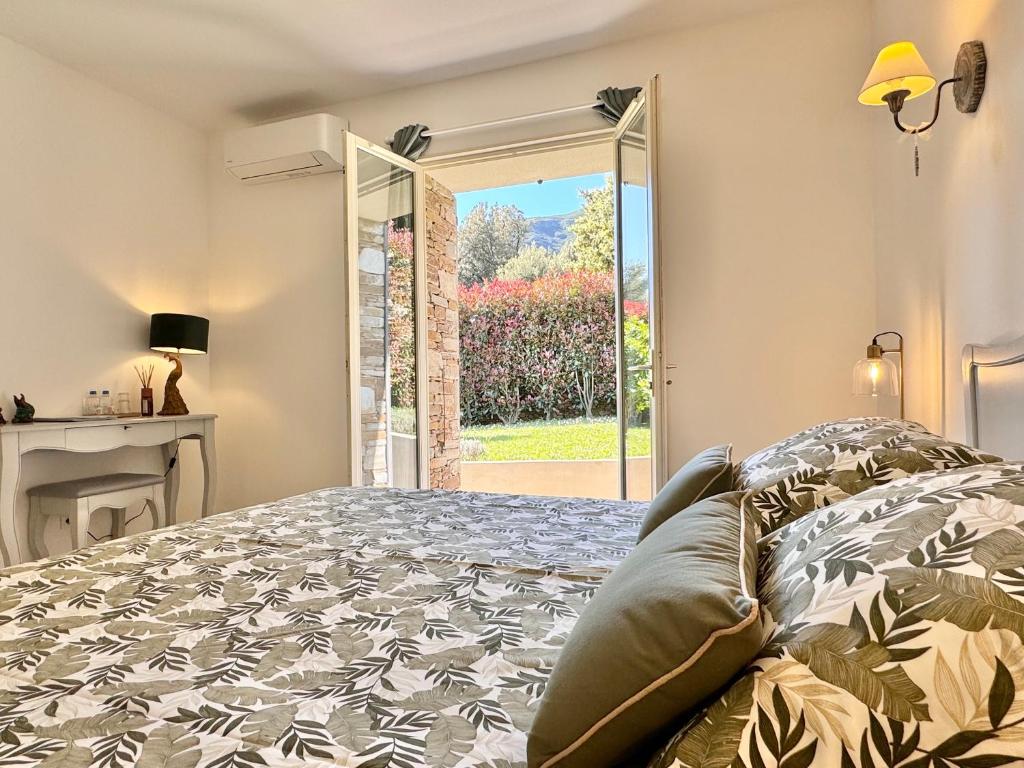 a bedroom with a bed and a window at Les 5 Arches in Sisco