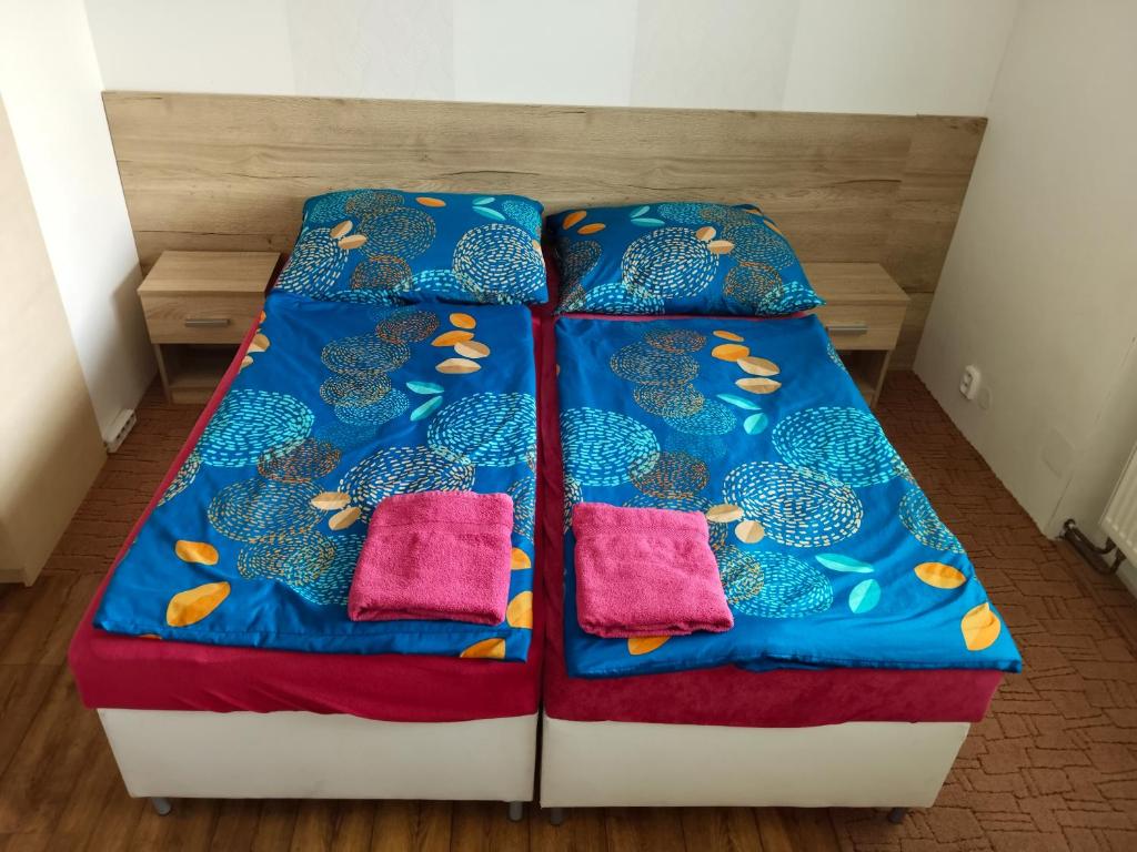 a bed in a room with two pillows on it at Apartmán se dvěma ložnicemi in Zlín