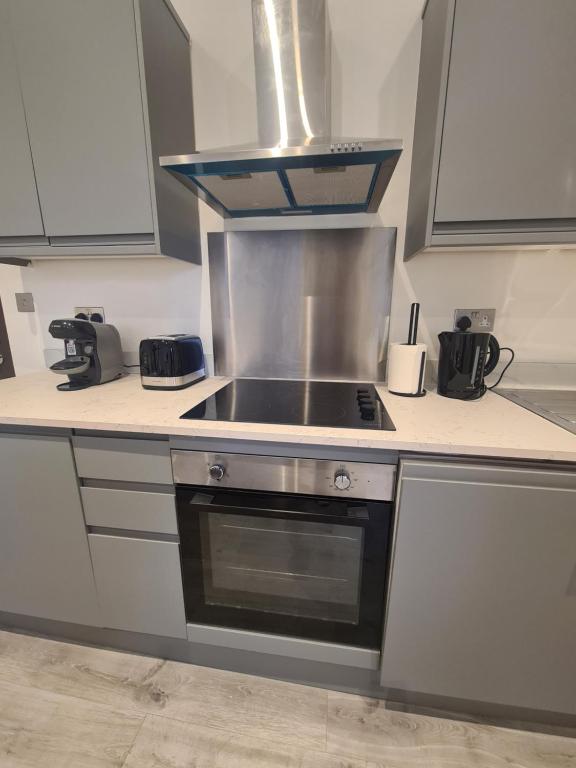uma cozinha com um fogão e um fogão forno superior em Luxury studio flat em Londres