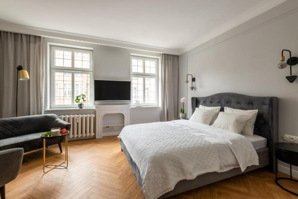 Una cama o camas en una habitación de Rytm miasta