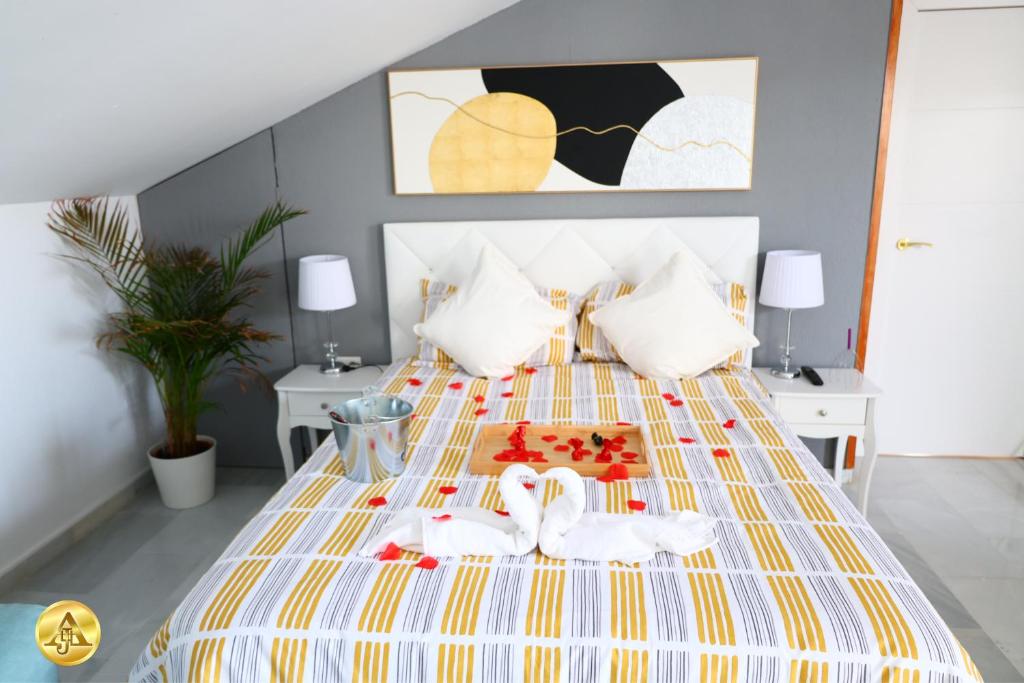 a bedroom with a bed with a yellow and white bedspread at A4J Luxury in Mijas