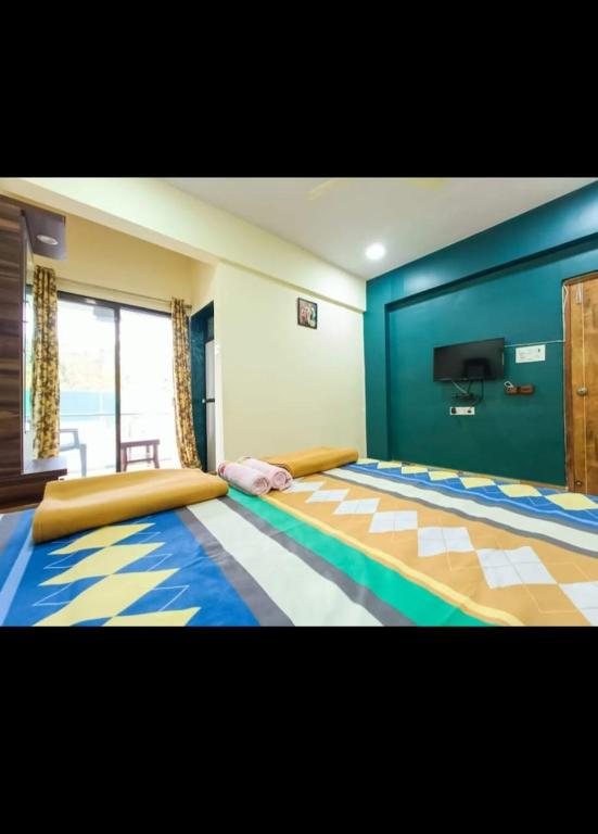a bedroom with a large bed with blue walls at Cornerpoint bungalows in Alibaug
