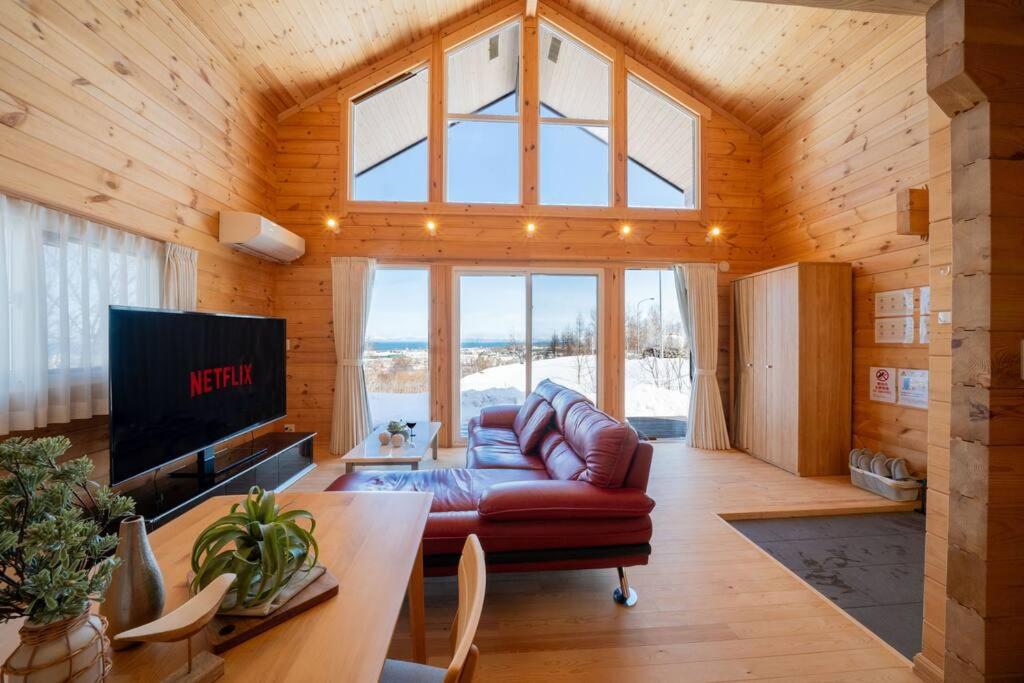 a living room with a couch and a large window at The Crestview Lodge 