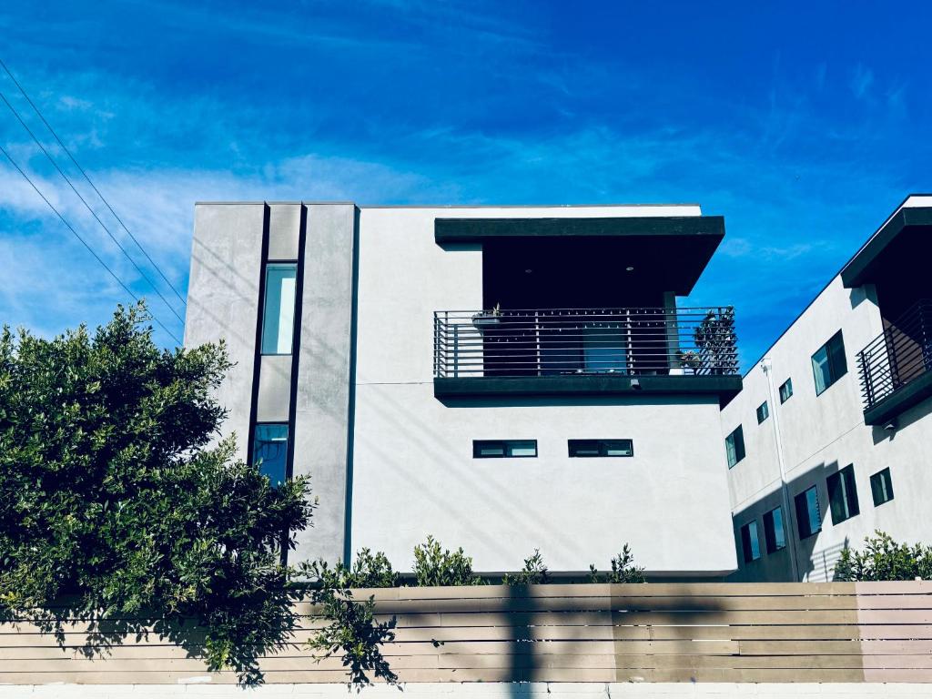 a white building with a blue sky in the background at Cozy Chamber 3 BR Hollywood Townhouse in Los Angeles