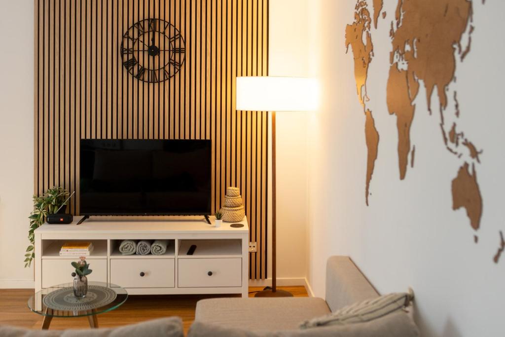 a living room with a flat screen tv on a wall at Gemütliches Apartment erstes OG NEU in Weilburg