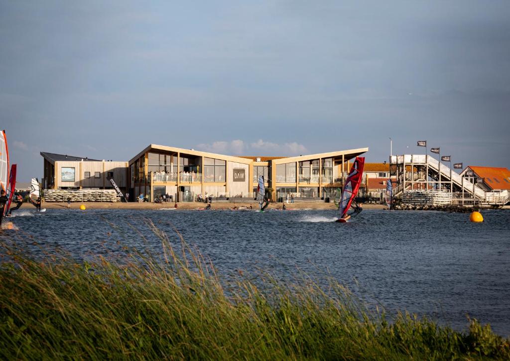 a building on the shore of a body of water at Brouwersdam Stay in Ouddorp