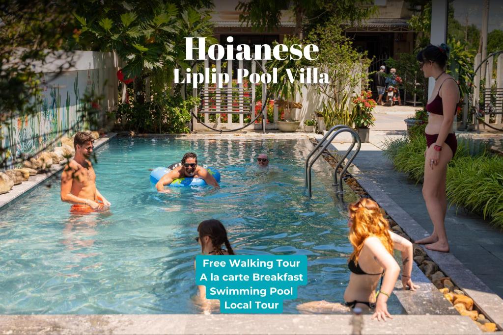 a group of people in a swimming pool at Hoianese Hotel - Lip Lip Pool Villa in Hoi An
