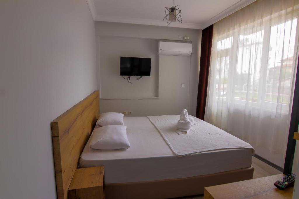 Postel nebo postele na pokoji v ubytování New Garden Hotel Side