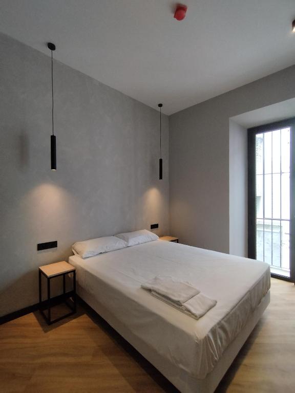 Postel nebo postele na pokoji v ubytování Sweet Sevilla Hostel