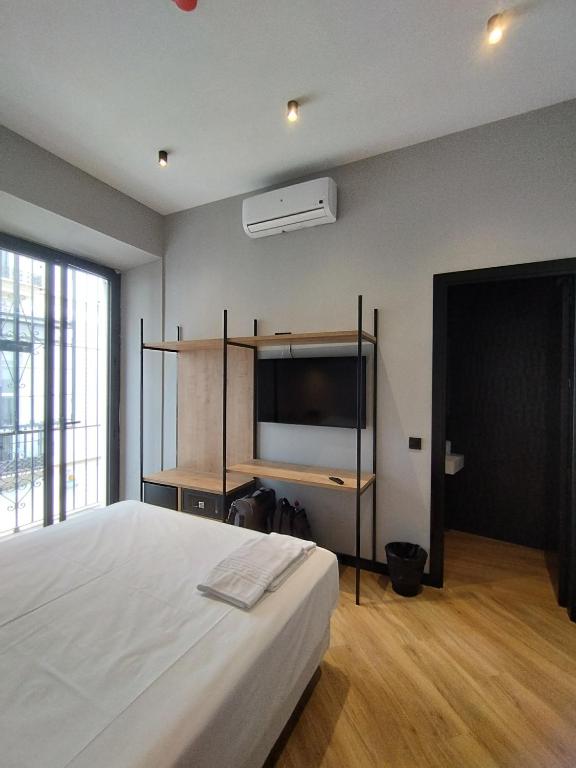 Postel nebo postele na pokoji v ubytování Sweet Sevilla Hostel