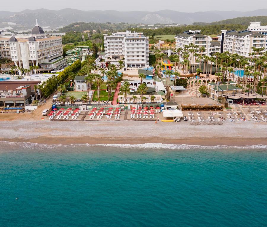an aerial view of a beach with buildings and the ocean at Holiday Garden Resort in Okurcalar