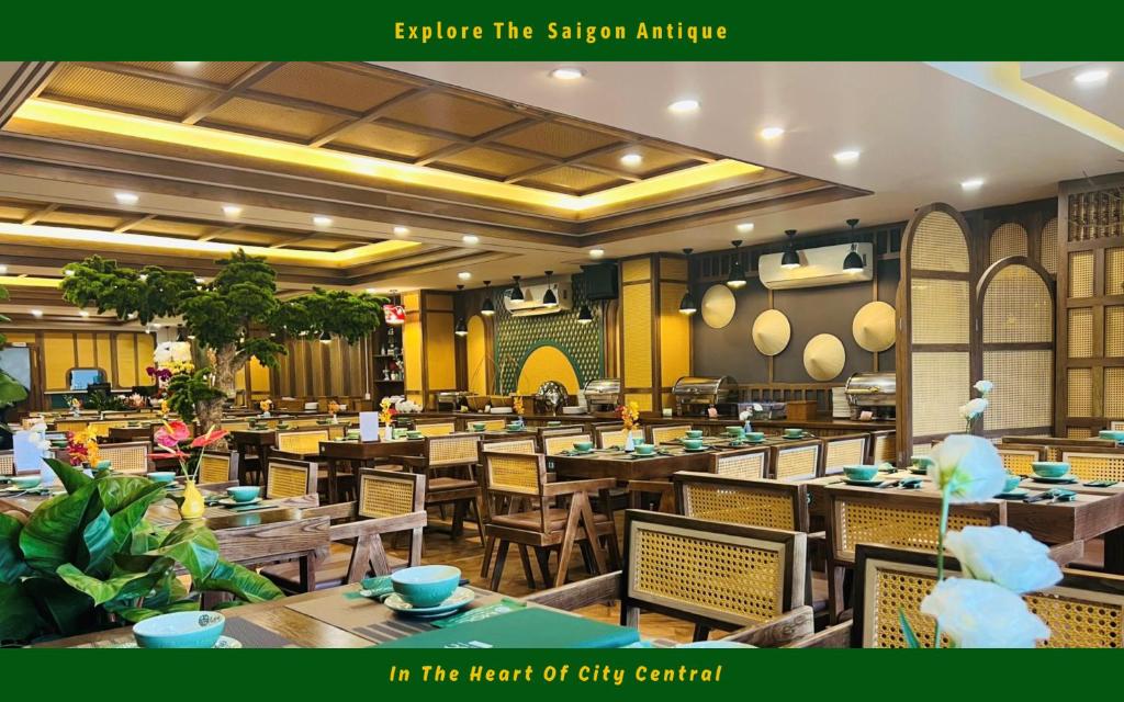 an empty restaurant with wooden tables and chairs at Happy Life Green Hotel in Ho Chi Minh City