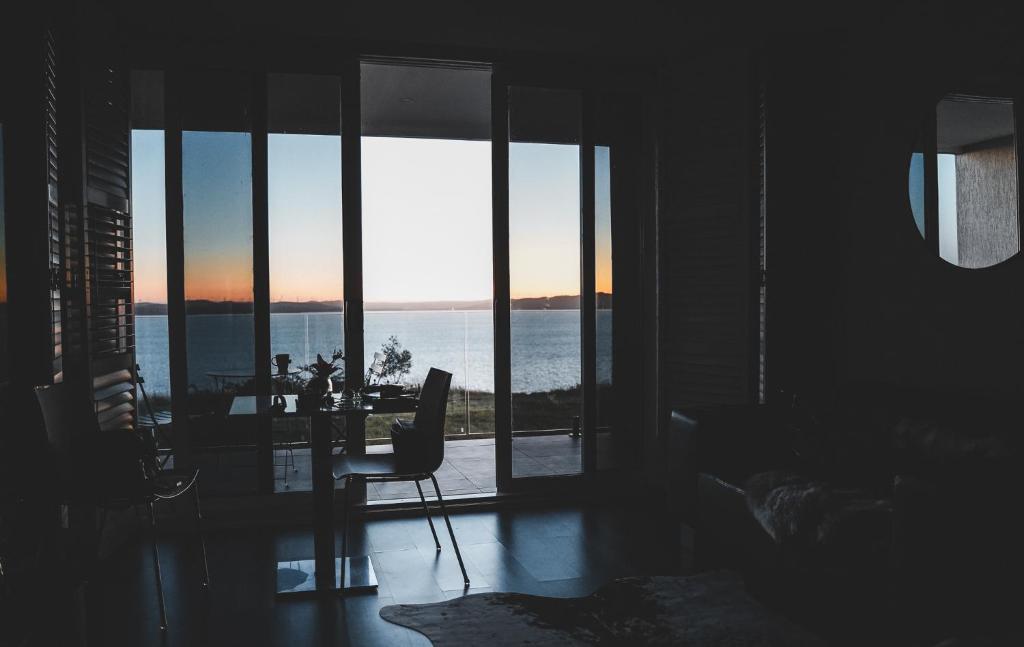 a living room with a view of the ocean at VistaMirage - Mystic Ridge Estate in Bywong