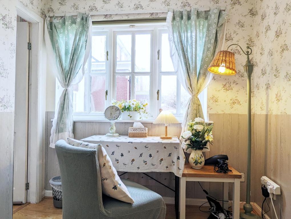 a room with a table and a window with a table and chairs at City Centre Vintage Theme Guest Rooms in Liverpool