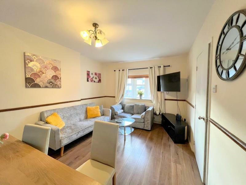 a living room with a couch and a table at London Central Acton House in London