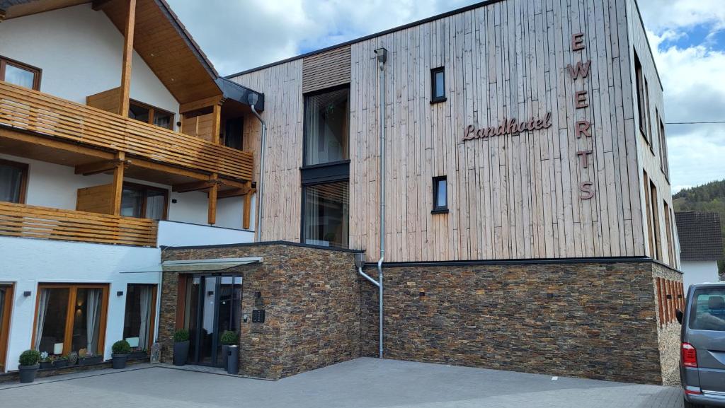 a building with a sign on the side of it at Landhotel Ewerts in Insul