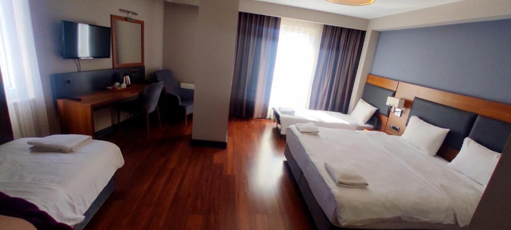 Postel nebo postele na pokoji v ubytování MD Barbaros Hotel