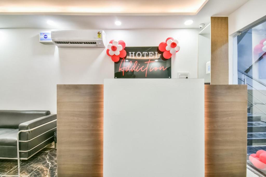 a hotel lobby with a sign and red balloons at Collection O 80868 Hotel Addiction in Patna