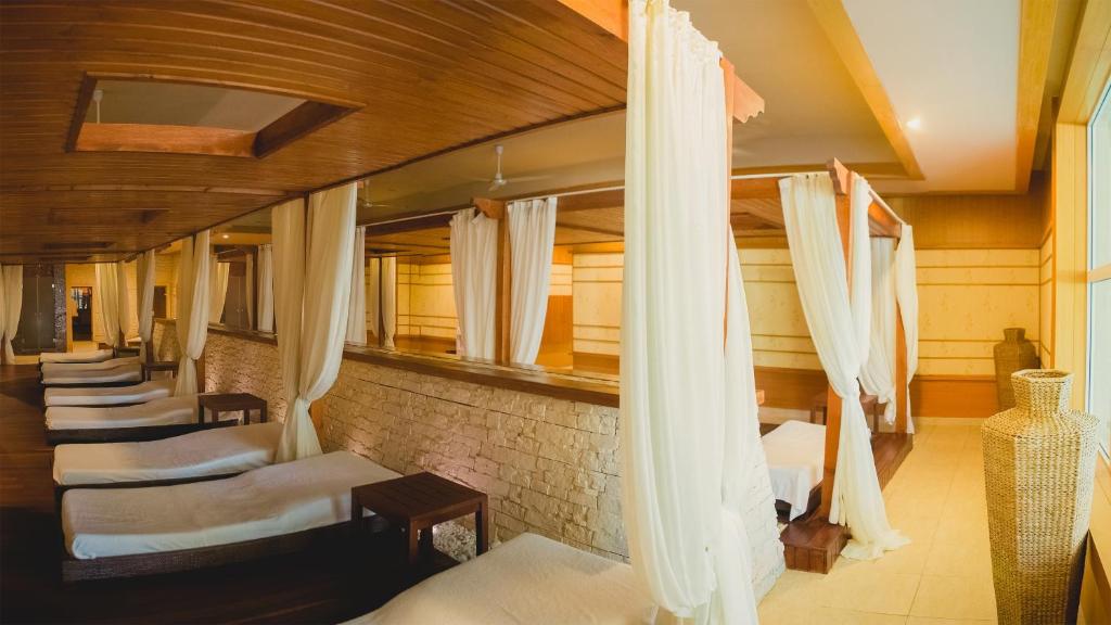 a row of beds in a room with curtains at Rixos-Prykarpattya Resort in Truskavets