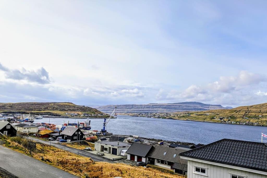 a view of a town next to a body of water at Cozy apartment in Runavík in Saltangará