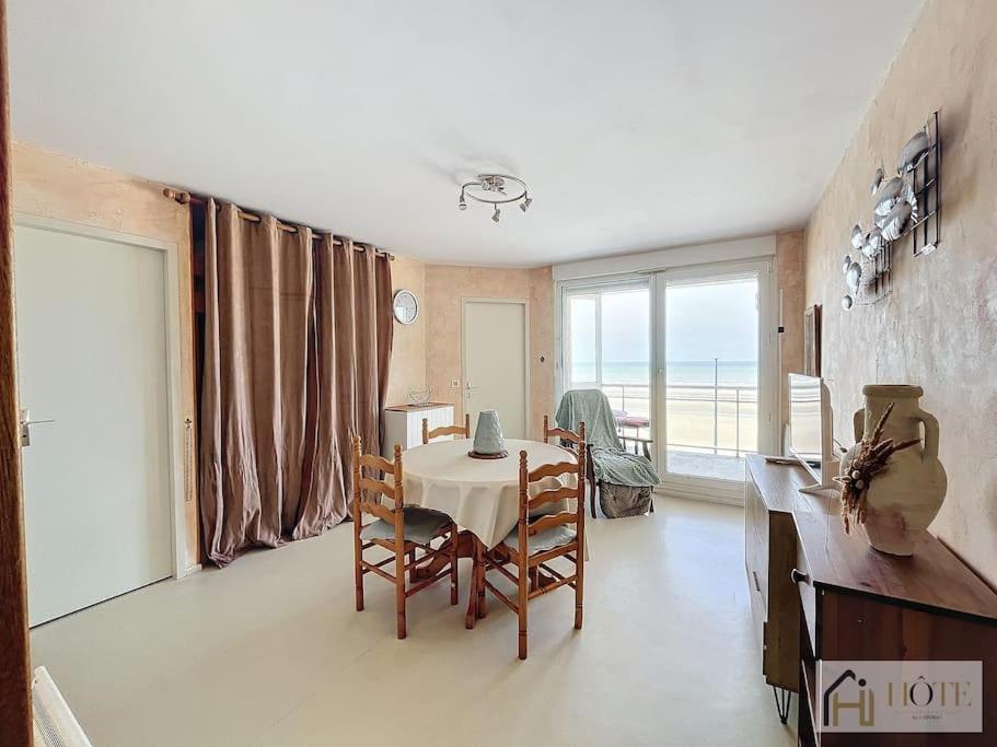 une salle à manger avec une table et des chaises et une fenêtre dans l'établissement Le Maeva -Vue Mer 3e Étage, à Bray-Dunes