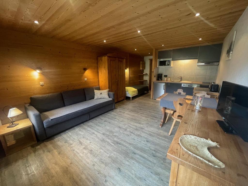 a living room with a couch and a table at Aravis Locations in Le Grand-Bornand