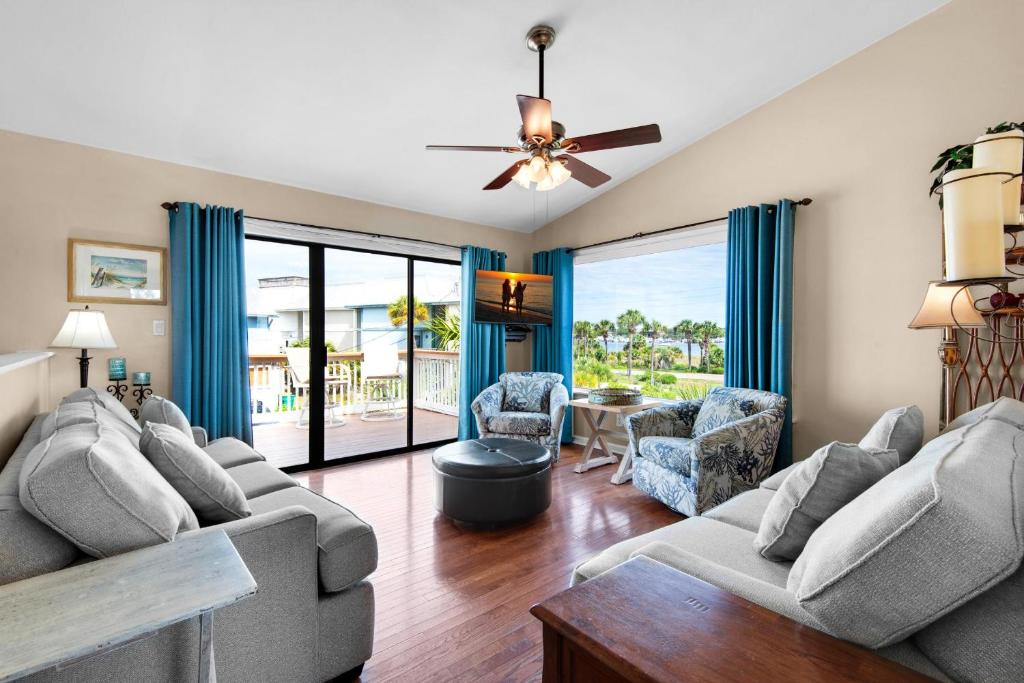 a living room with two couches and a ceiling fan at Beach Side- Harbor View in Destin