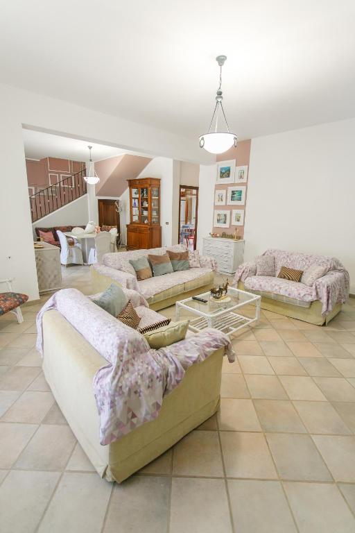 a large living room with couches and tables at SanVitoTour- Residence Il Baglio in San Vito lo Capo
